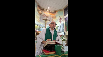 A priest has the cross fall on him while he was preparing to do his speech